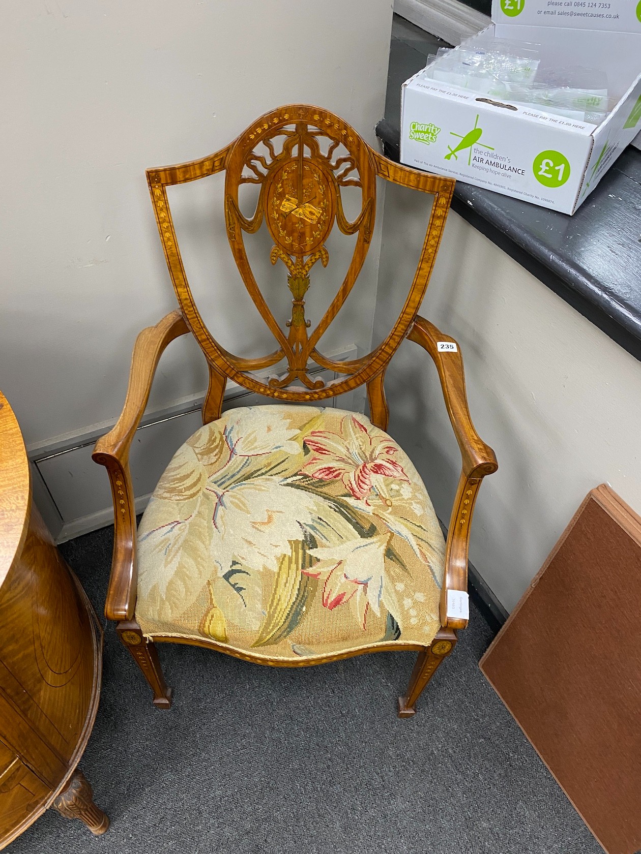 An Edwardian Sheraton revival marquetry inlaid satinwood elbow chair